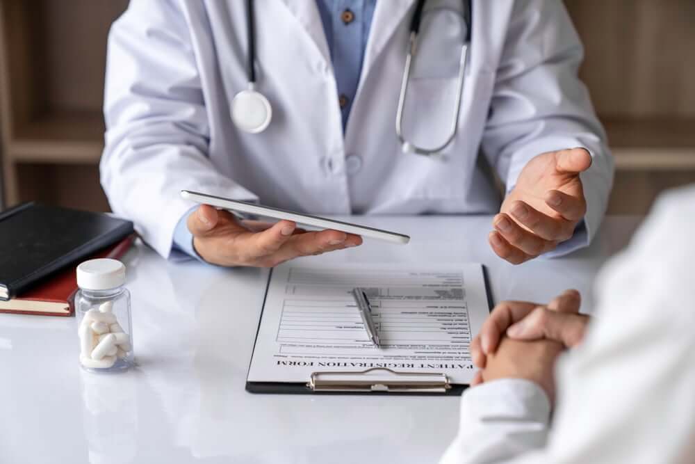 A truck overturned in a snow-covered field with visible damage.