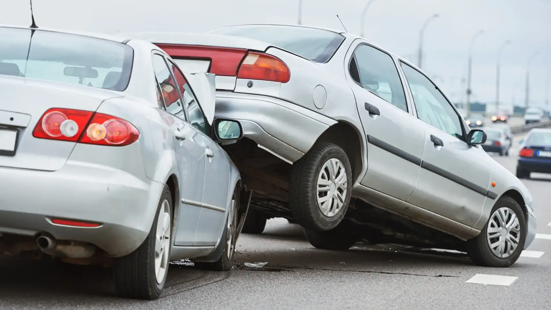 A multi-car accident where one vehicle is partially lifted onto another.