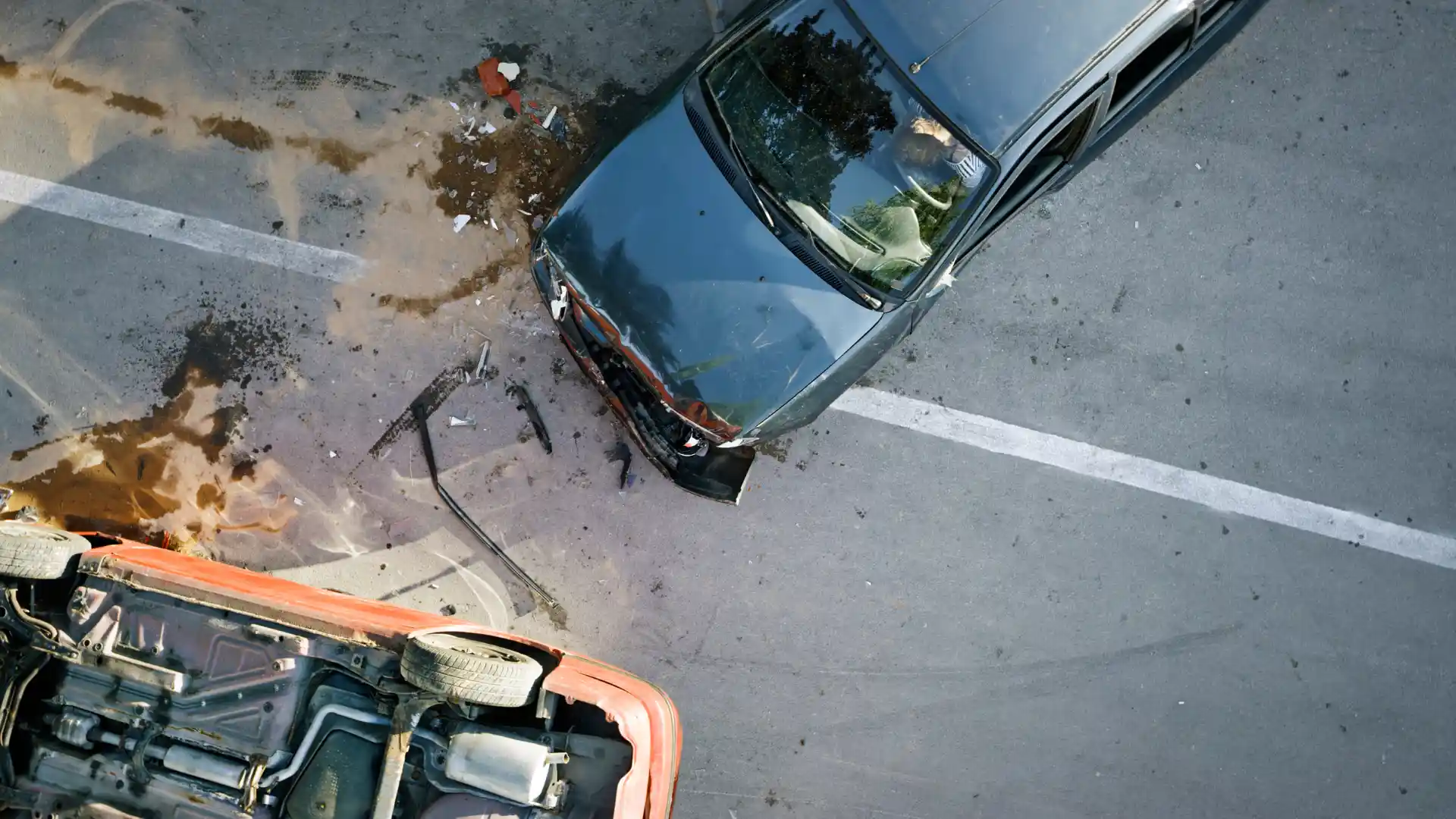 Aerial view of a car accident with visible damage and debris.