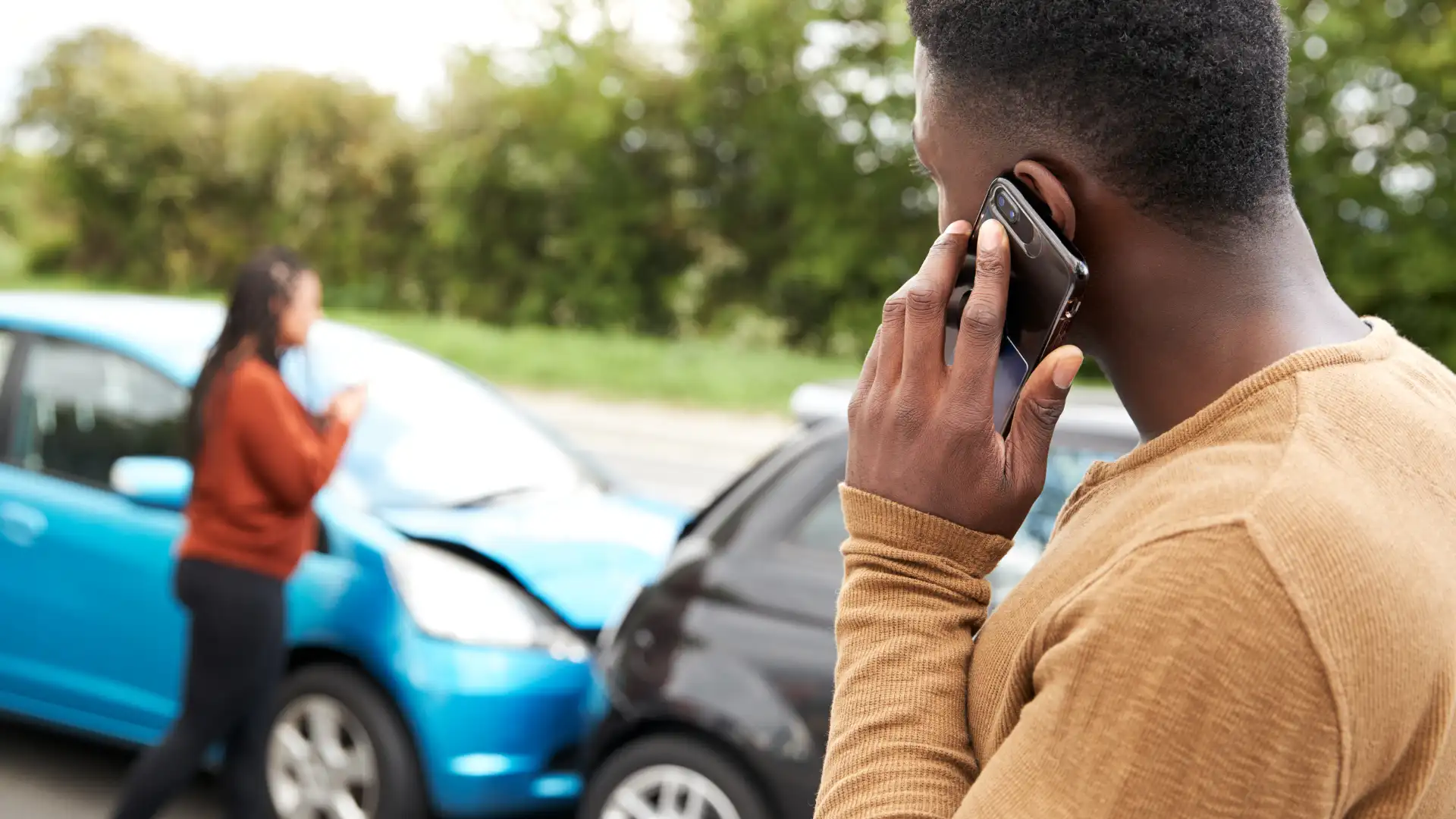 Person on the phone after a car accident
