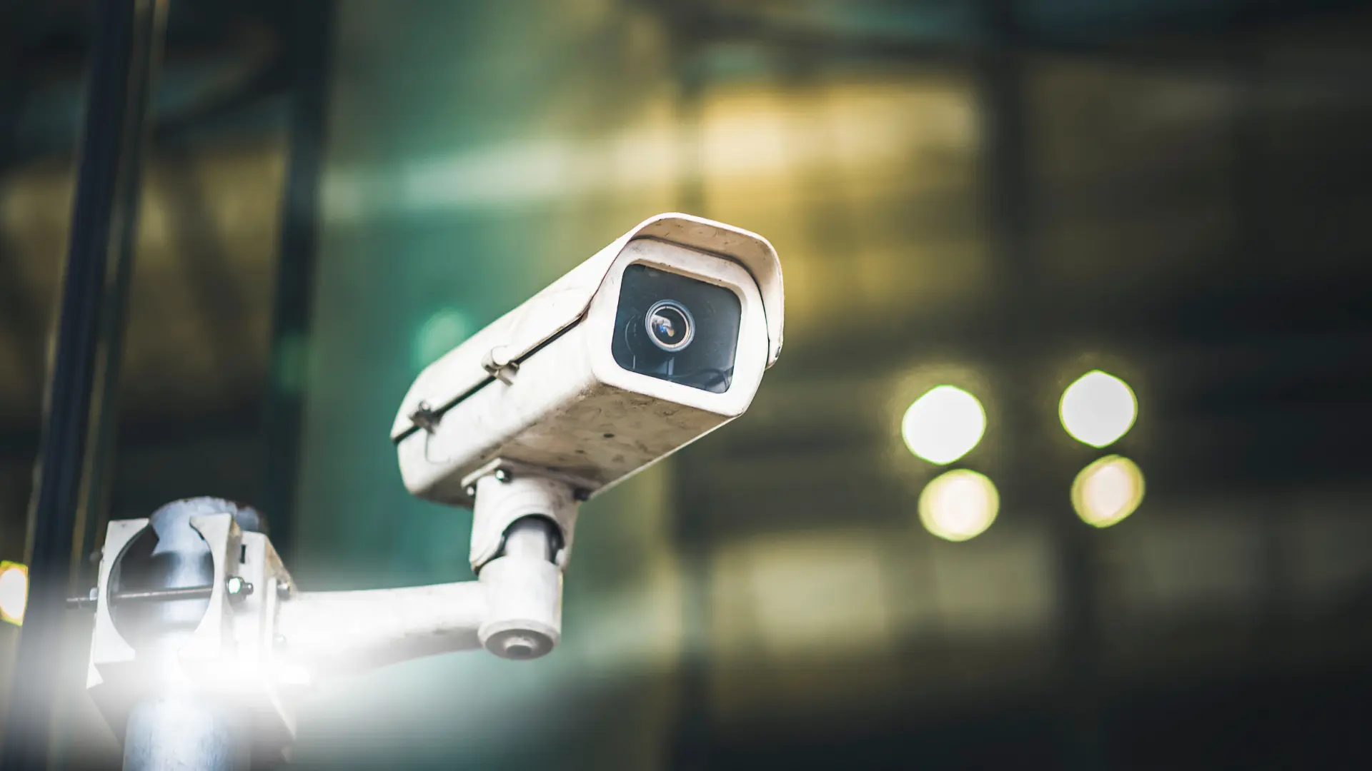 Close-up of a security camera with a blurry background.