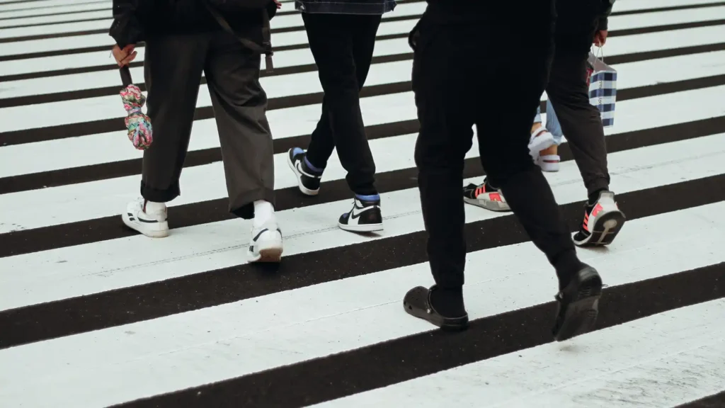 people walking in a pedestrian crossing